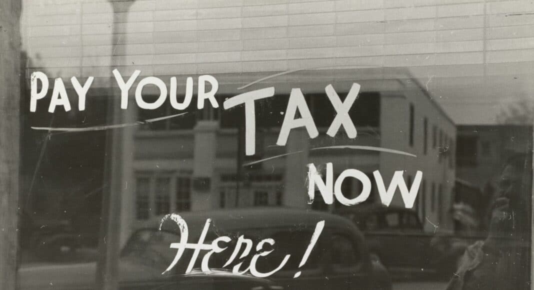 a sign that says pay your tax now here