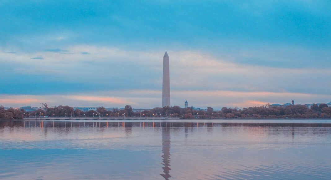 white concrete building near body of water during daytime