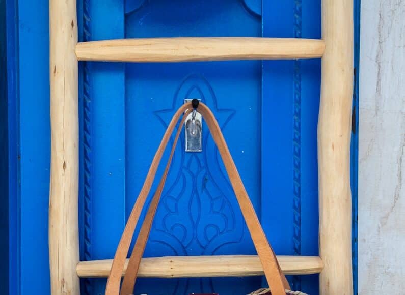 brown leather tote bag hanging on wall