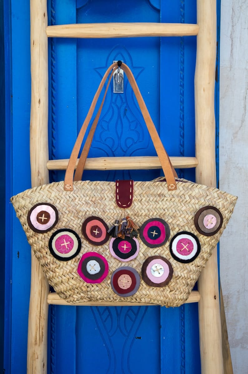 brown leather tote bag hanging on wall