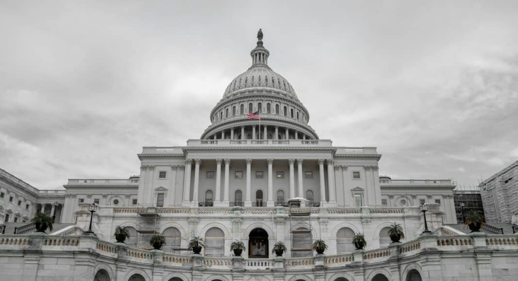 people walking around white concrete building during daytime