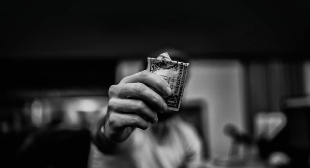man holding 1 US dollar banknote