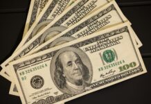 a stack of twenty dollar bills sitting on top of each other