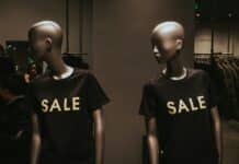 two mannequins with black Sale graphic crew-neck t-shirts