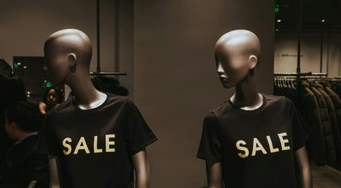 two mannequins with black Sale graphic crew-neck t-shirts