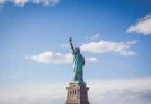 L’administration Trump suspend l’USAID et gèle l’aide humanitaire mondiale Statue of Liberty, New York under white and blue cloudy skies