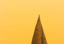 a sailboat in the middle of a body of water