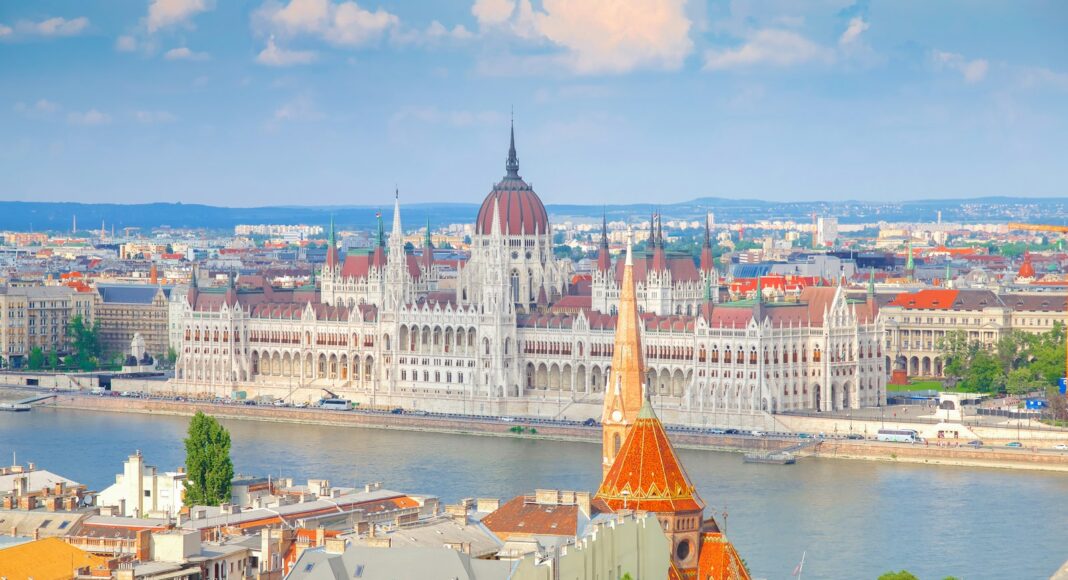 aerial photography of concrete buildings beside body of water during daytime