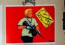 man in blue shirt holding rifle painting