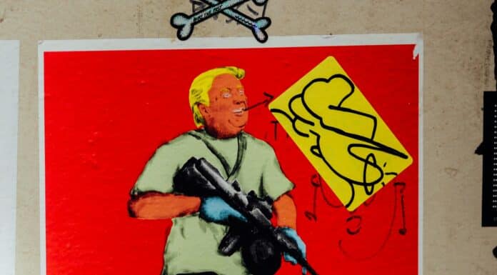 man in blue shirt holding rifle painting