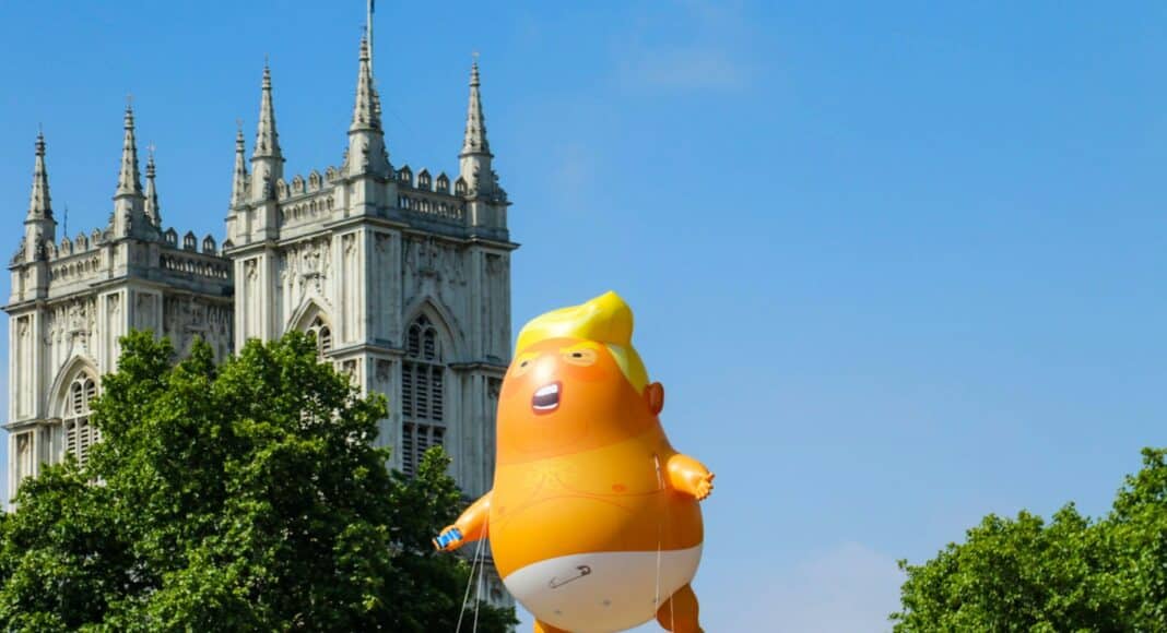 yellow balloon near white concrete building during daytime