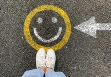person in white shoes standing on gray concrete road