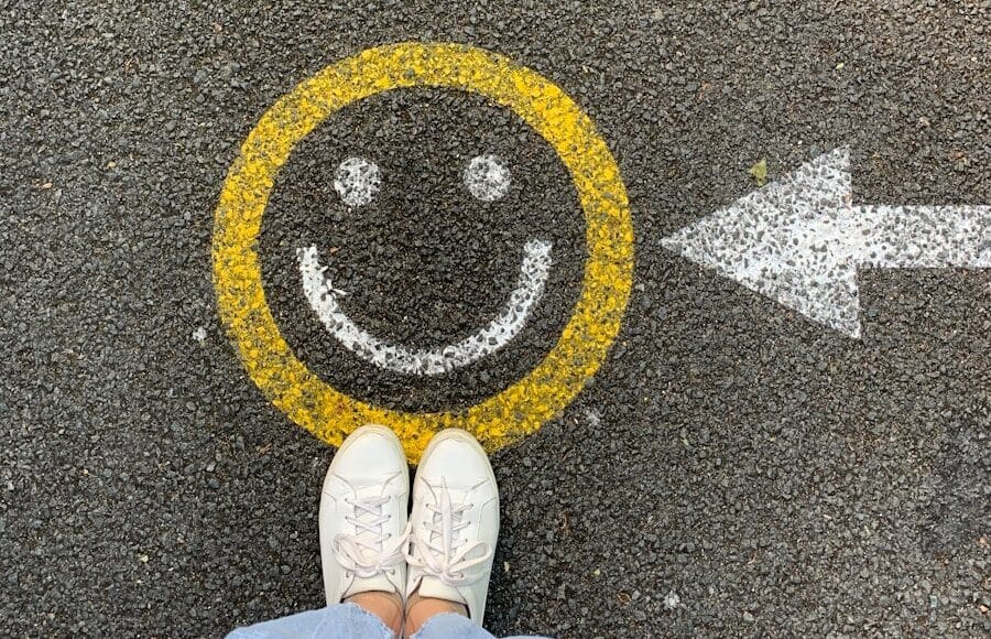 person in white shoes standing on gray concrete road