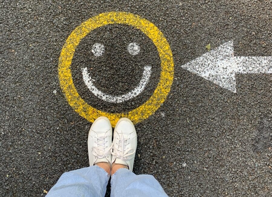 person in white shoes standing on gray concrete road