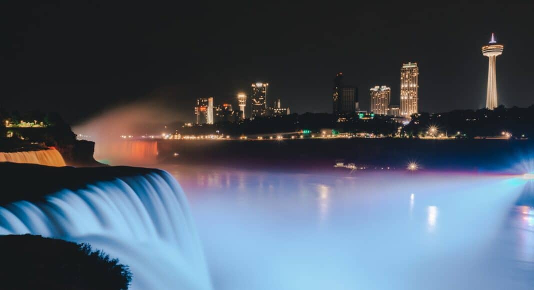 water fountain near city buildings during night time