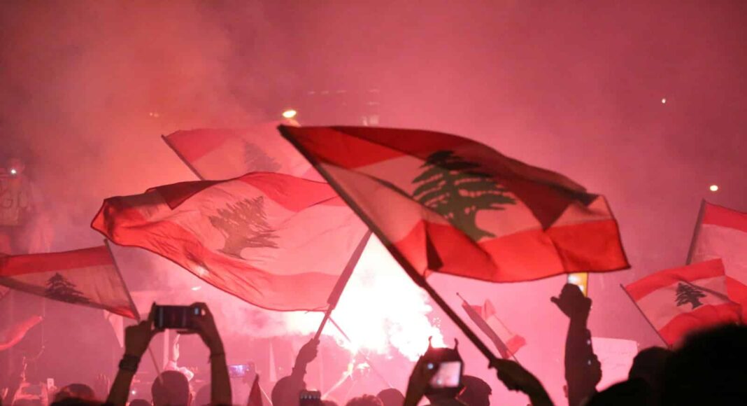 people raising flags during night time