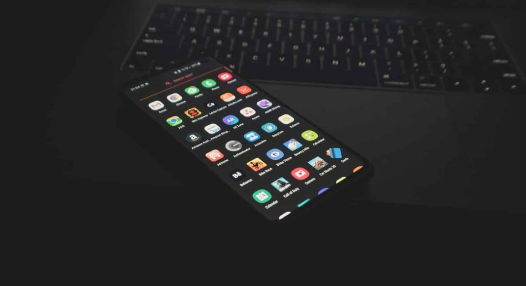 black iphone 5 on black computer keyboard