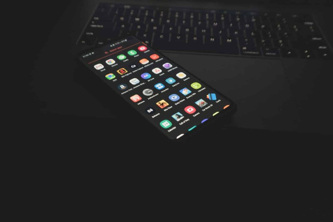 black iphone 5 on black computer keyboard