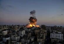 A large fire is burning in a city