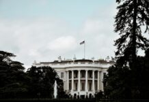 a white house with a flag on top of it