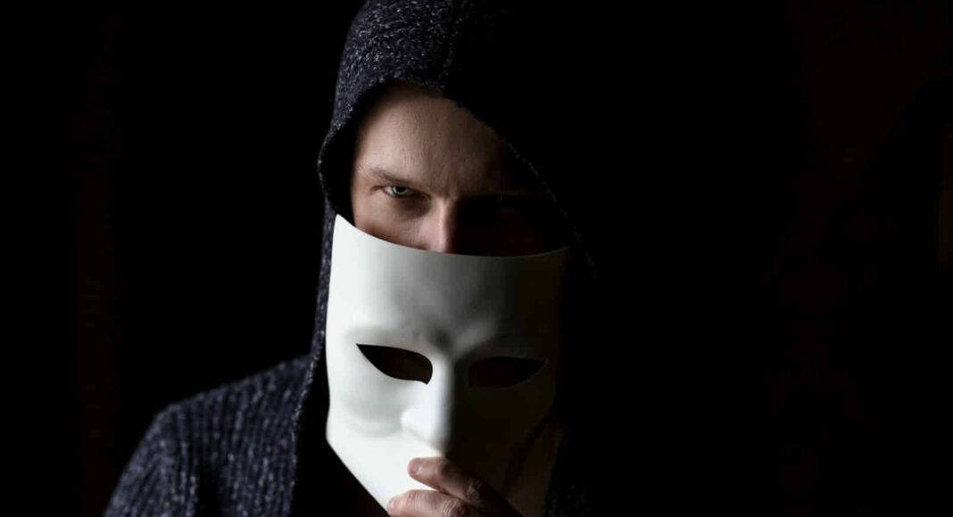 person in black knit cap and gray sweater