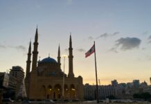 a large building with a flag flying in front of it