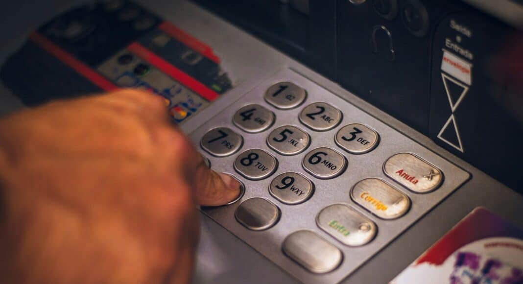 person holding white and red card