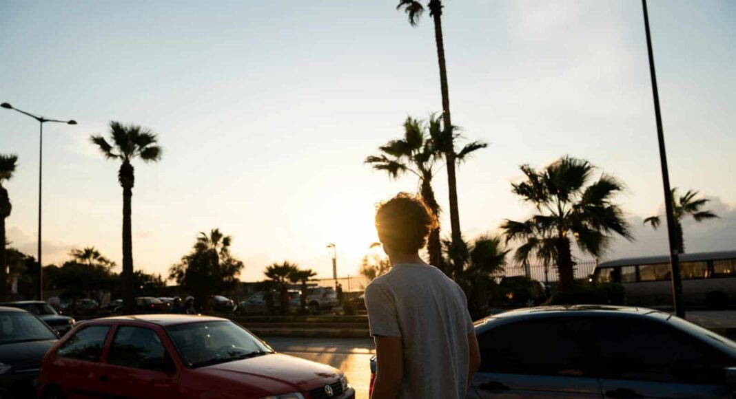 man walking near parked vehicles