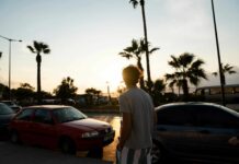 man walking near parked vehicles
