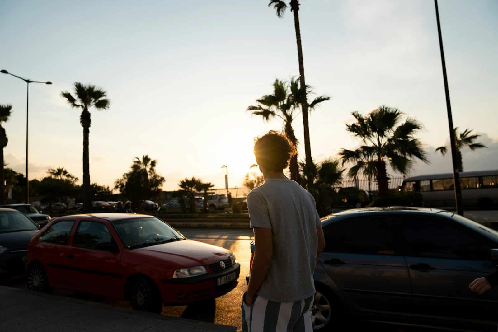 man walking near parked vehicles