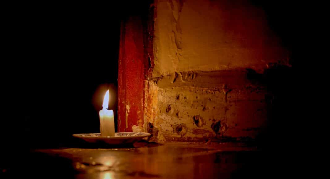 a lit candle sitting on top of a table