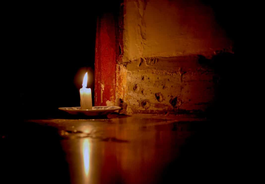 a lit candle sitting on top of a table