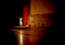 a lit candle sitting on top of a table