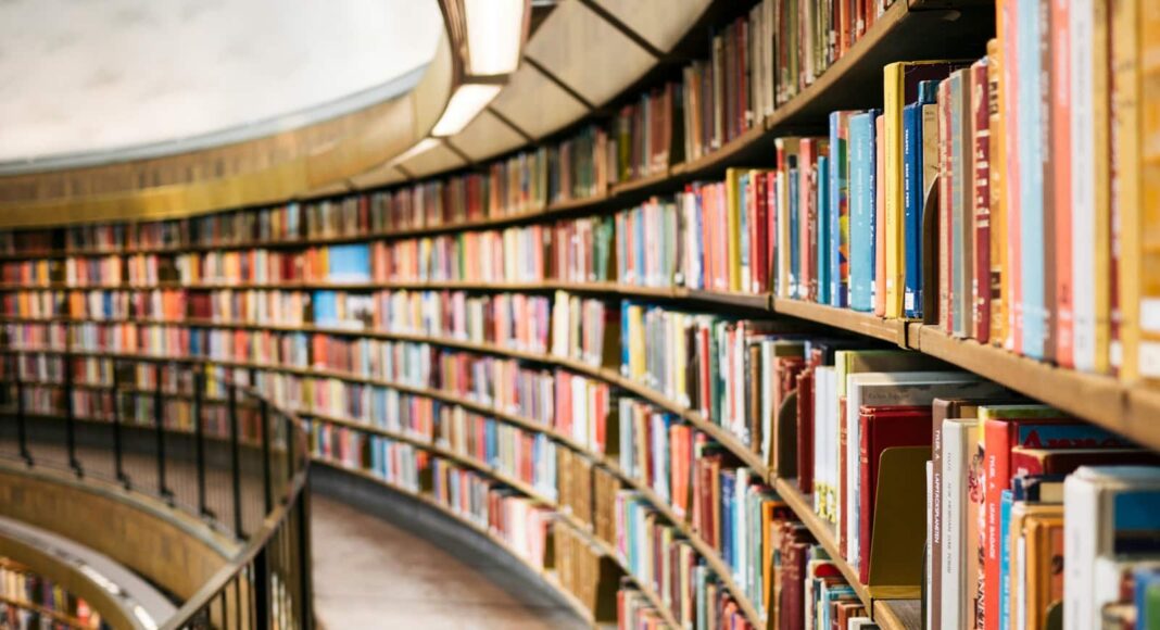 books on brown wooden shelf
