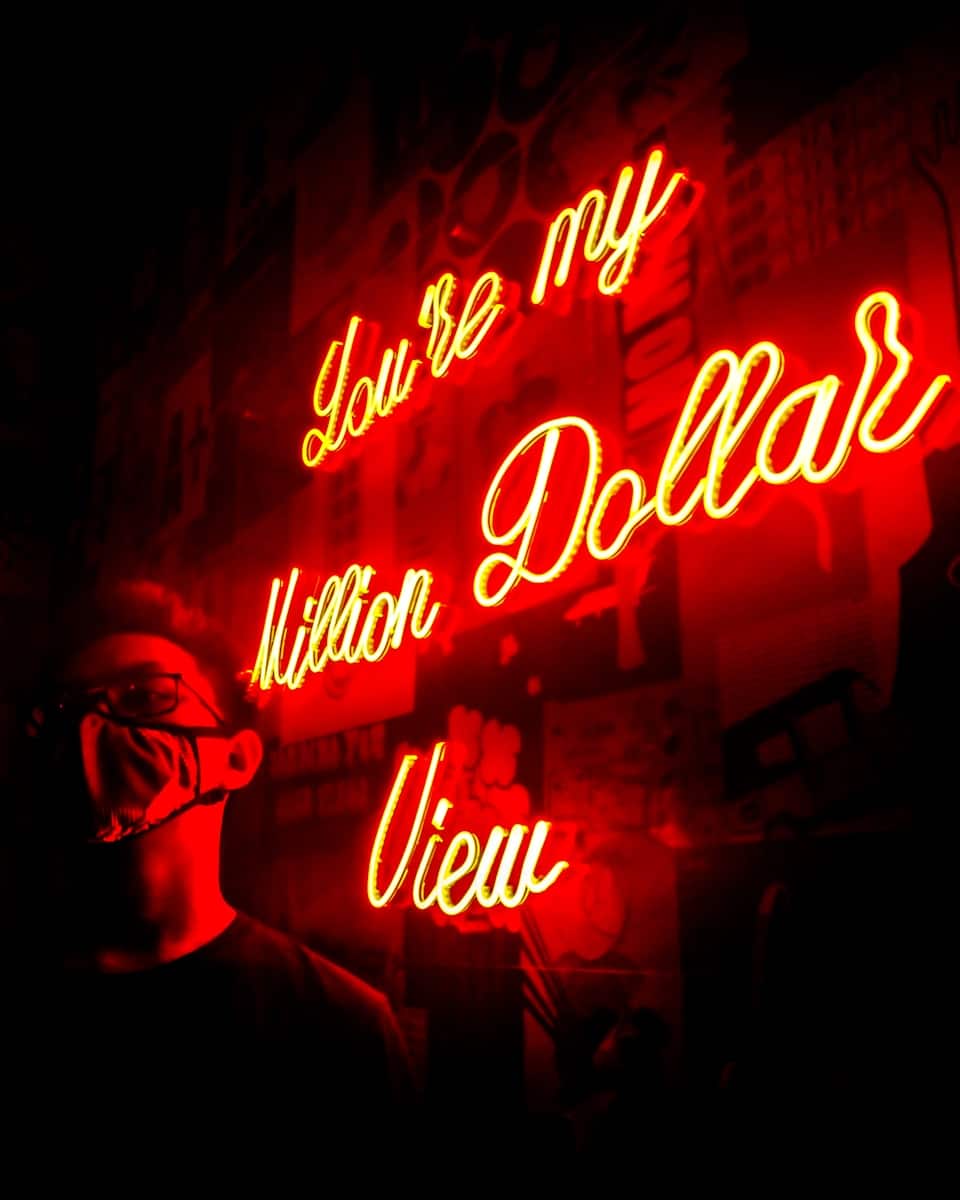 man standing near the LED signage