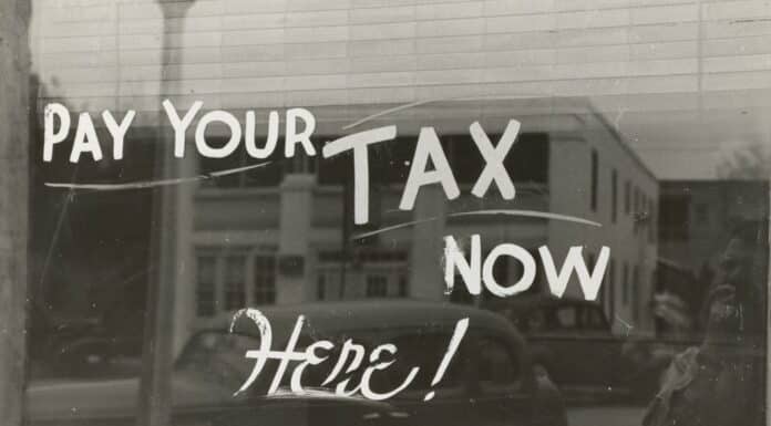 a sign that says pay your tax now here