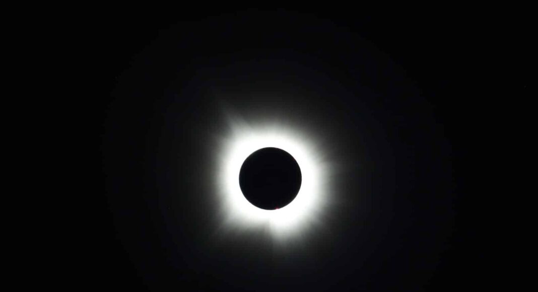 a solar eclipse is seen in the dark sky