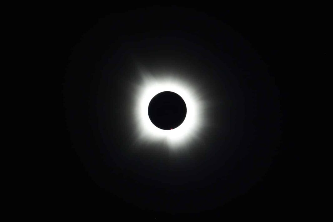 a solar eclipse is seen in the dark sky
