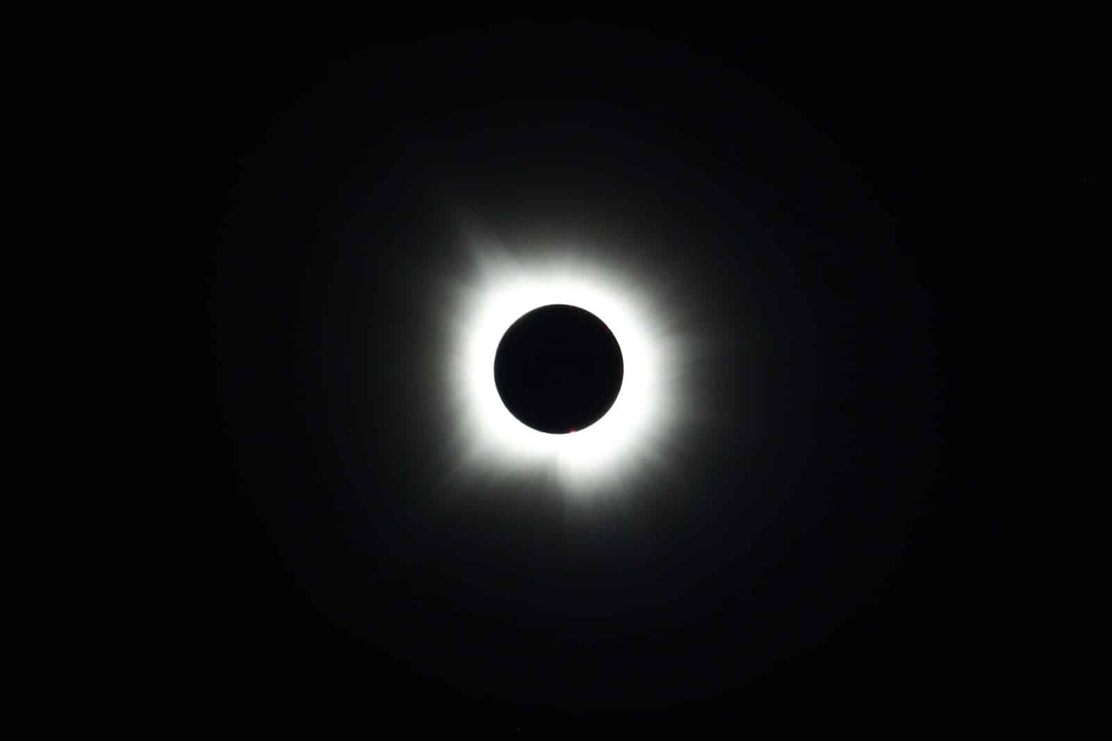 a solar eclipse is seen in the dark sky