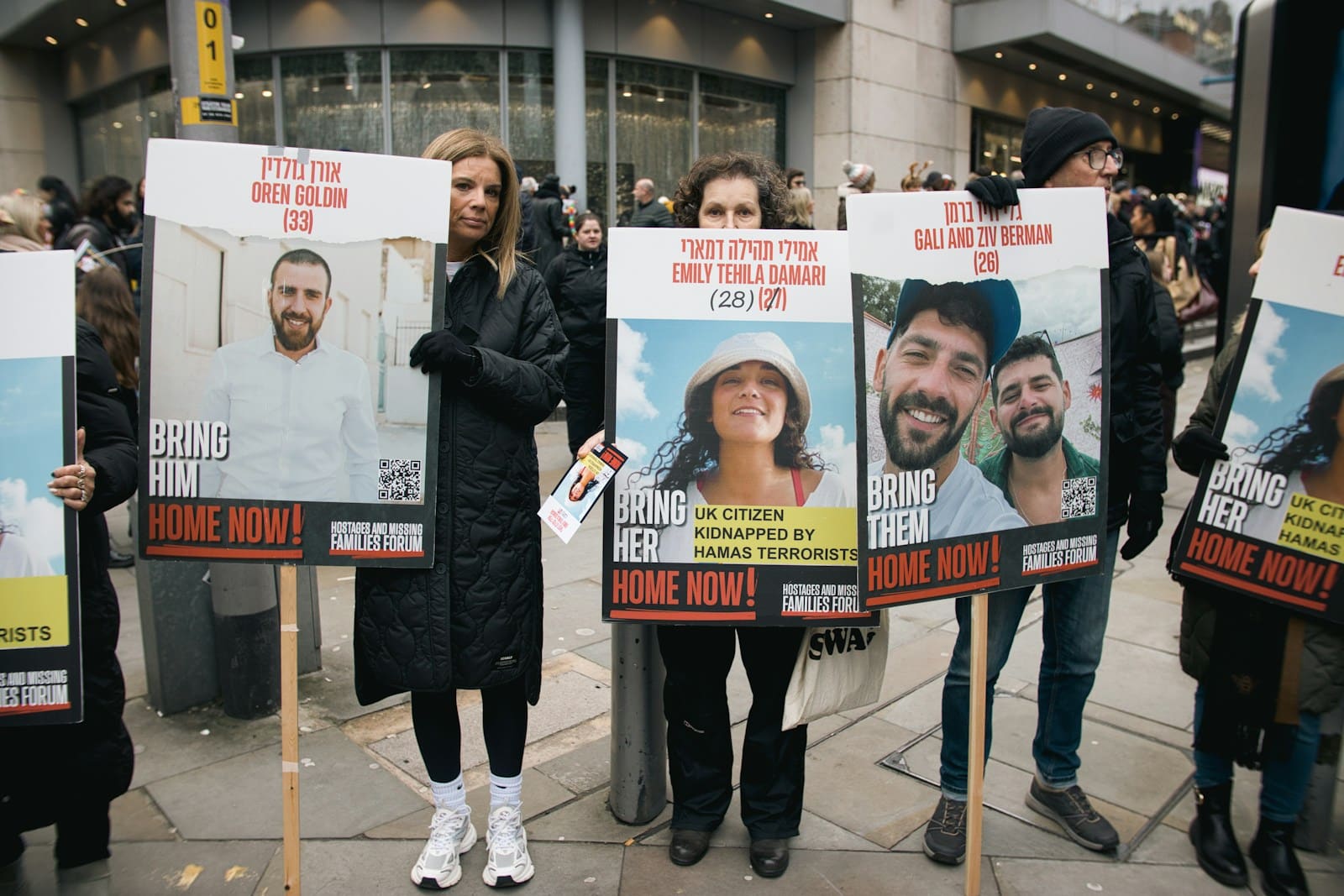 A group of people holding up signs on the street