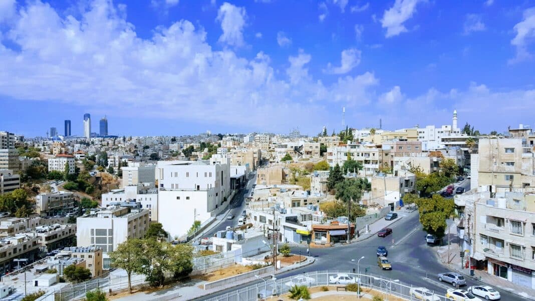 cars on road near city buildings during daytime