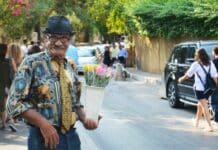 man holding flowers during daytime