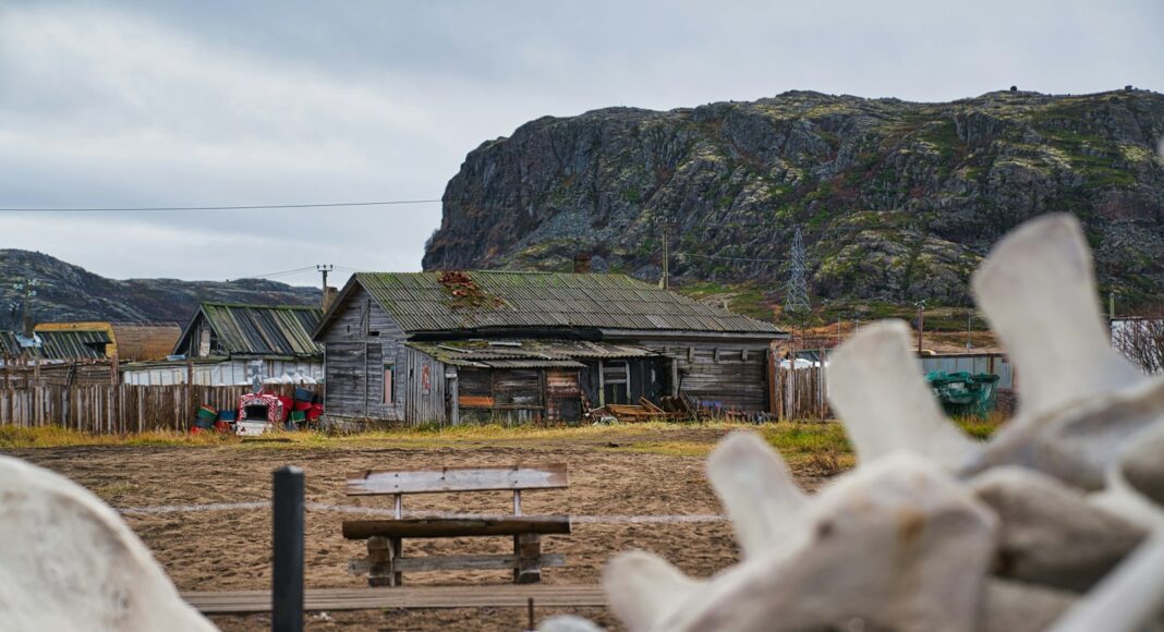 a wooden bench sitting in front of a building