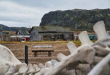 a wooden bench sitting in front of a building
