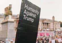 humanity against trump signage near buildings