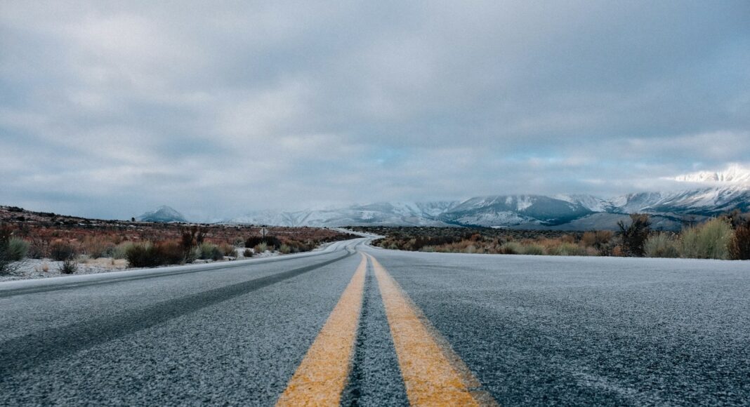 landscape photography of asphalt road under cloudy sky during daytime