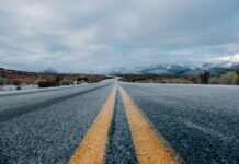 landscape photography of asphalt road under cloudy sky during daytime