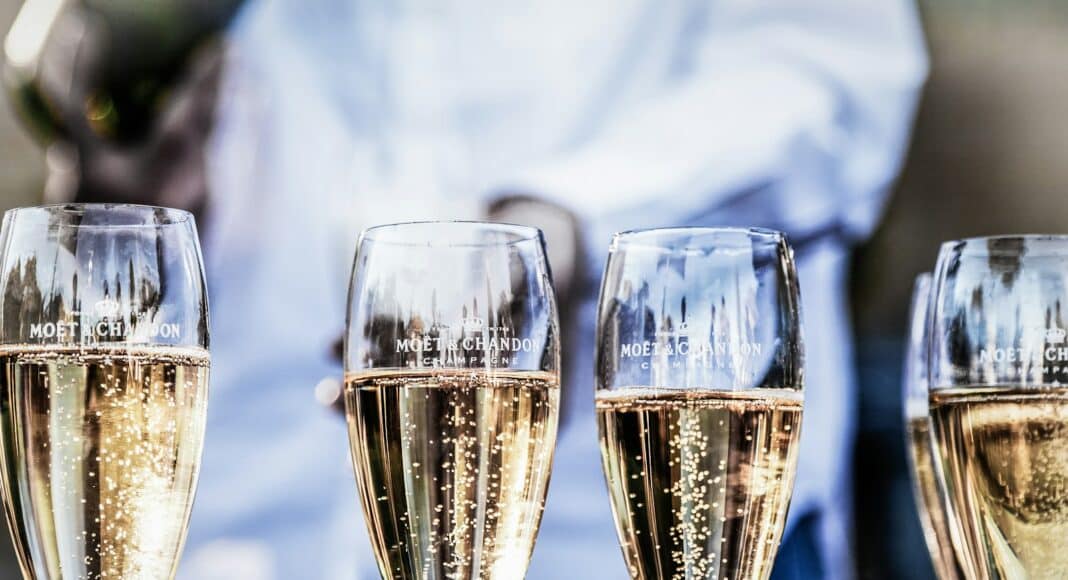 four clear champagne flutes